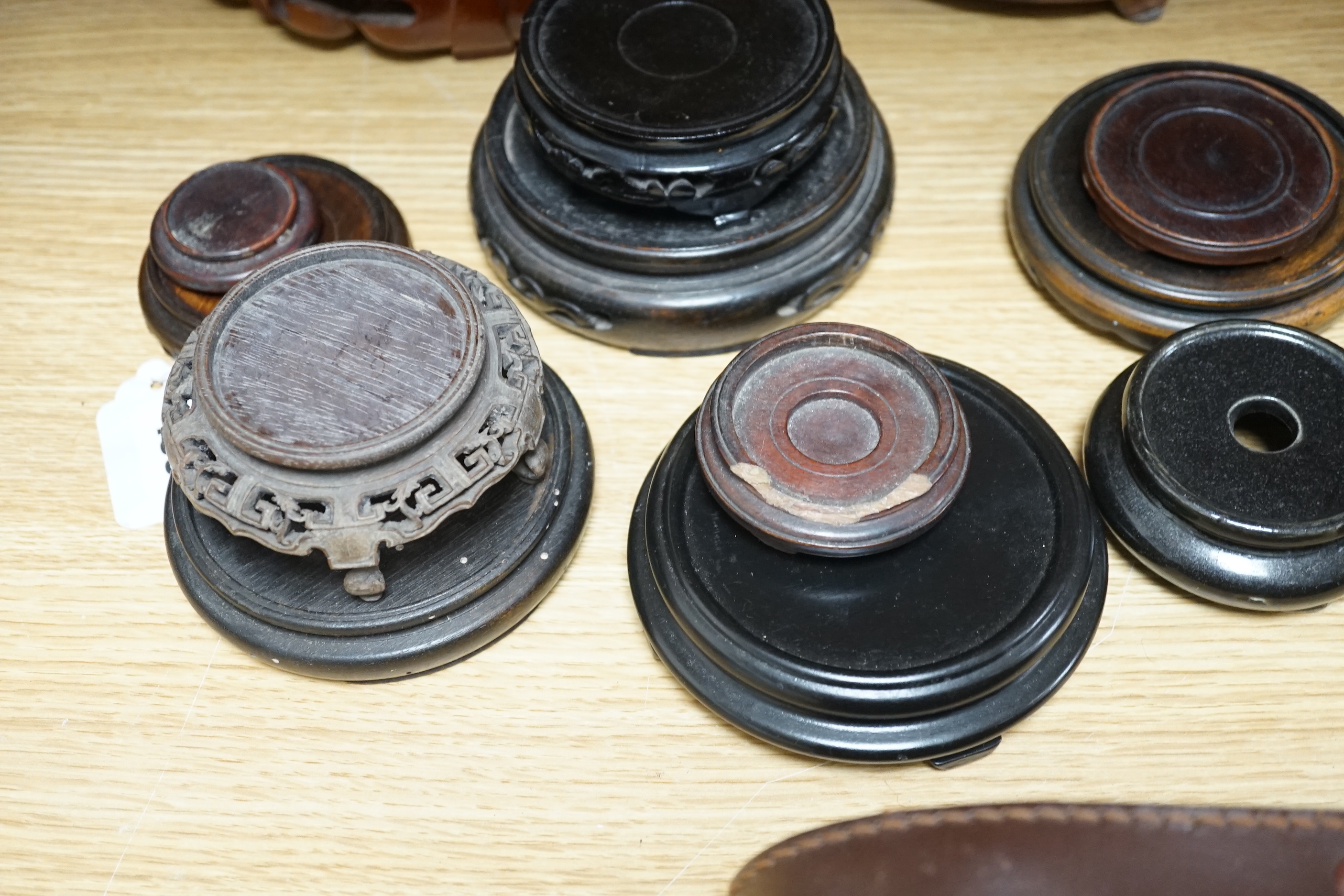 A group of Chinese hardwood stands, some with pierced and carved decoration, largest 22cm in diameter
